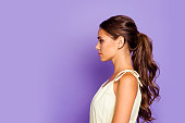 Close-up profile side view portrait of nice-looking well-groomed attractive stunning lovable fascinating magnificent winsome chic content wavy-haired girl isolated over violet pastel background