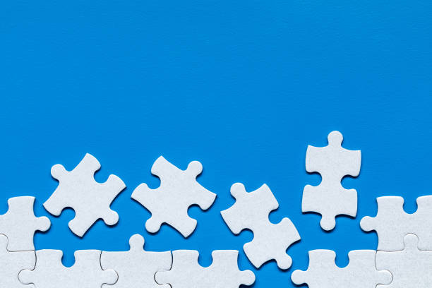 istock White jigsaw puzzle. White puzzle pieces on color background. Unfinished white jigsaw puzzle pieces on color background. 1146671799