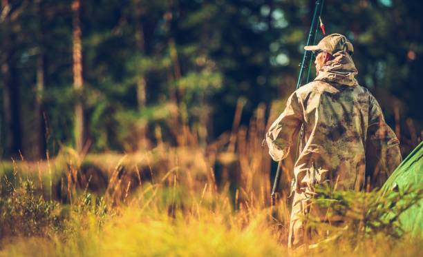 Caucasian Hunter in the Wild Caucasian Hunter in the Wild. Men in His 30s with Fishing Rod in Hand. fishing rod photos stock pictures, royalty-free photos & images
