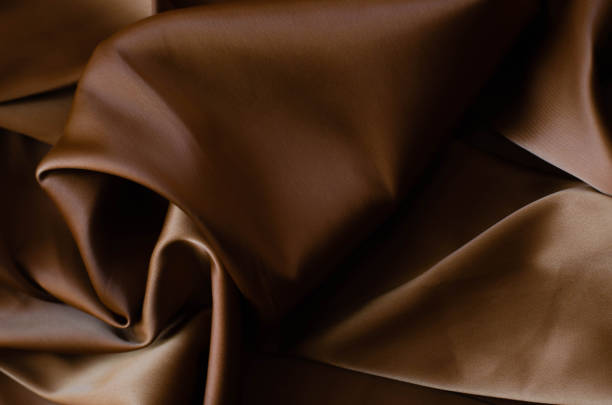 istock Background from satin fabric of brown color. 1146674775
