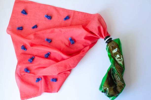 istock Plastic bottle with a coral cloth on which the blue flowers. 1146674816