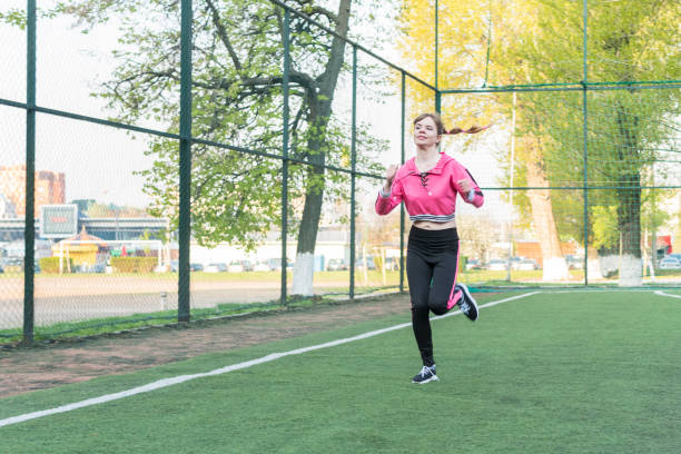 istock woman runs through the stadium 1146675095