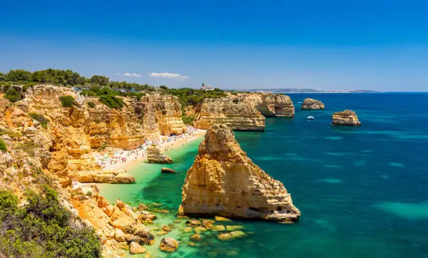 Photo of Praia da Marinha, beautiful beach Marinha in Algarve, Portugal. Navy Beach (Praia da Marinha), one of the most famous beaches of Portugal, located on the Atlantic coast in Lagoa Municipality, Algarve.