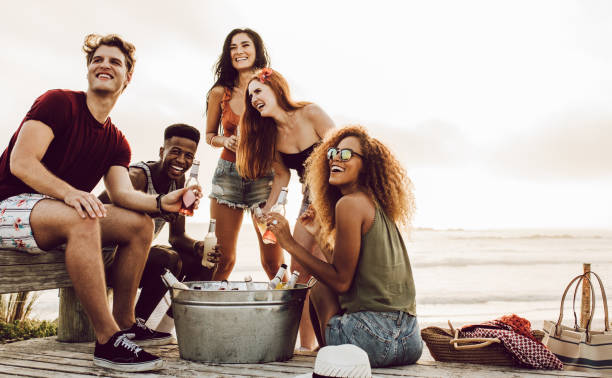 istock Multiracial friends hanging out at the beach 1146679087