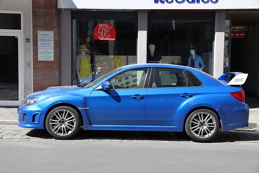 Blue Subaru Impreza WRX STI sports sedan car parked in Germany. There were 45.8 million cars registered in Germany (as of 2017).