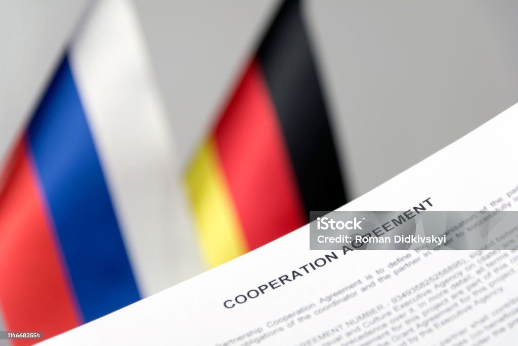 russia germany flag nord stream 2 contract blurred background Agreement Stock Photo
