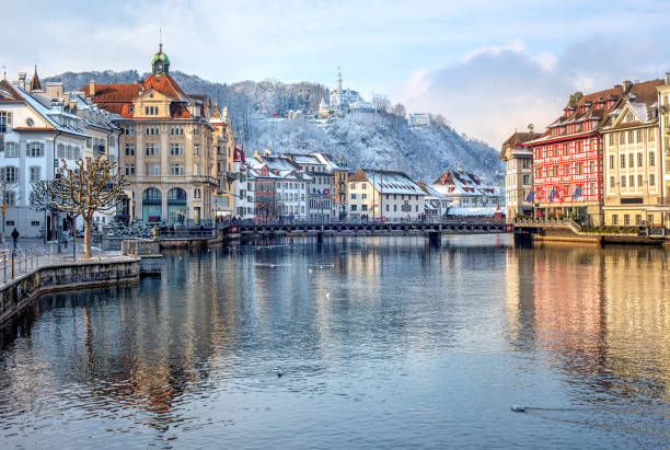 Lucerne city, Switzerland, snow white in winter time Lucerne city, Switzerland, view of the Old Town covered with white snow in winter, reflecting in the river medieval architecture stock pictures, royalty-free photos & images