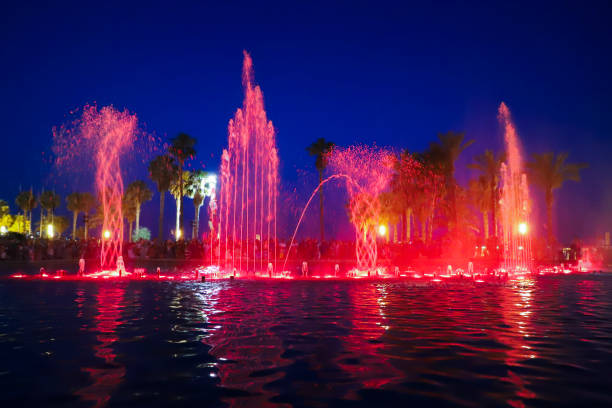 Singing fountain in Salou Spain, illuminated by a bright colored light.