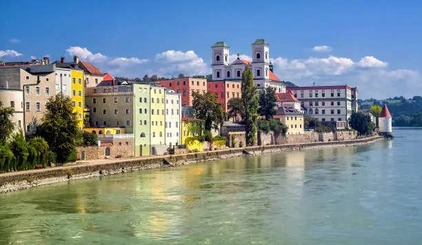 Colorful traditional houses facing Inn river in historical old town Passau, Germany