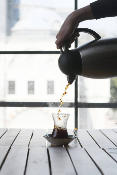 istock Female hand pouring tea into turkish glass 1146688712