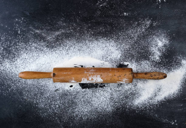istock wooden rolling pin on a black background 1146689556