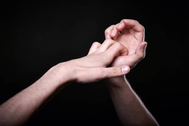 istock two beautiful man's hands in the dark 1146692793