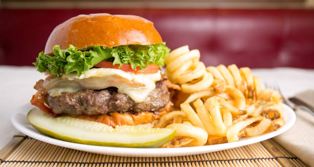 istock Cheeseburger with curly spiral fries 1146693496