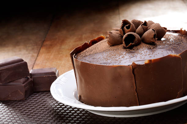 istock Chocolate cakes, chocolate pies, wood background, icing sugar, strawberry pie, cakes 1146694090