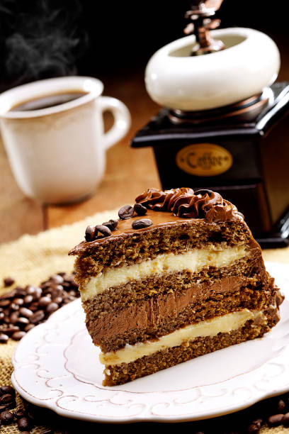 Chocolate cake and coffee beans with fork on plate