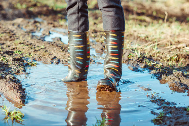 istock feet in boots in mud 1146697116