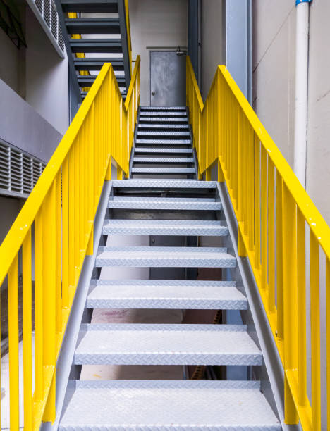 Metal fire escape with the yellow ladder. Metal fire escape with the yellow ladder on the office building. caution step stock pictures, royalty-free photos & images