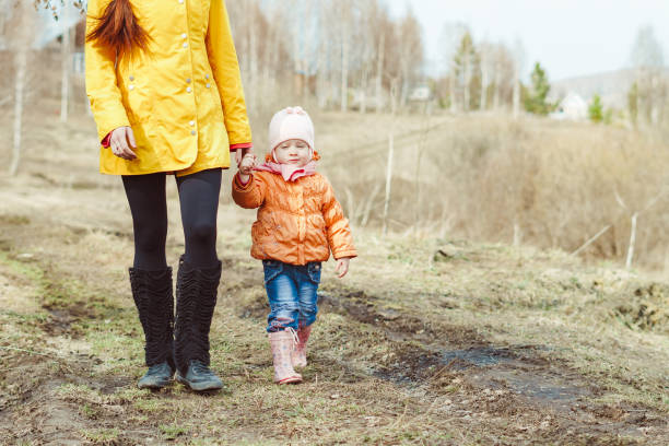 istock mother with a child walking in autumn forest 1146700183