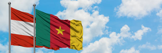 Austria and Cameroon flag waving in the wind against white cloudy blue sky together. Diplomacy concept, international relations. Austria and Cameroon flag waving in the wind against white cloudy blue sky together. Diplomacy concept, international relations. yaounde photos stock pictures, royalty-free photos & images