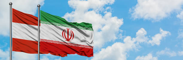 istock Austria and Iran flag waving in the wind against white cloudy blue sky together. Diplomacy concept, international relations. 1146703473