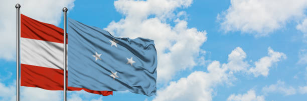 istock Austria and Micronesia flag waving in the wind against white cloudy blue sky together. Diplomacy concept, international relations. 1146703535