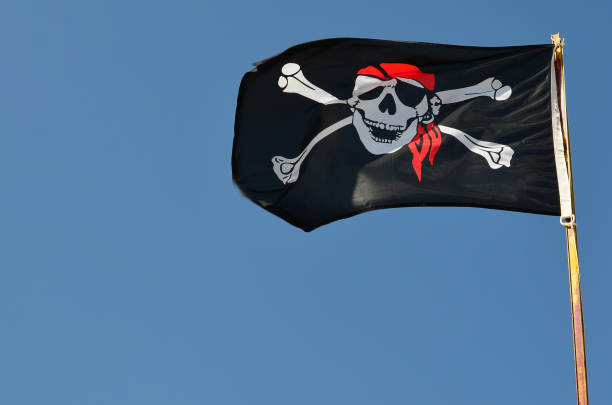 istock Pirate flag against blue sky, copy space 1146703754