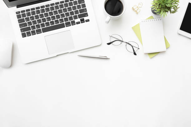 istock White office desk table with laptop computer and supplies. Top view with copy space, flat lay. 1146705043