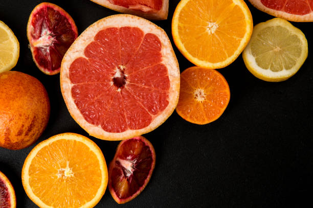 istock Top view, macro. Sliced colorful citrus on a dark background. Copy space right below. 1146705879