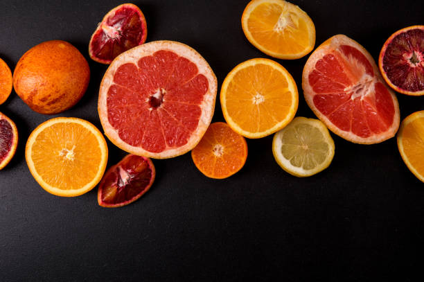 istock Top view. Sliced bright citrus on a black background. Copy space. 1146705898