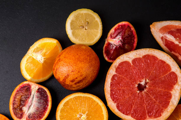 istock Top view, macro. Sliced bright citrus on a black background. 1146706010