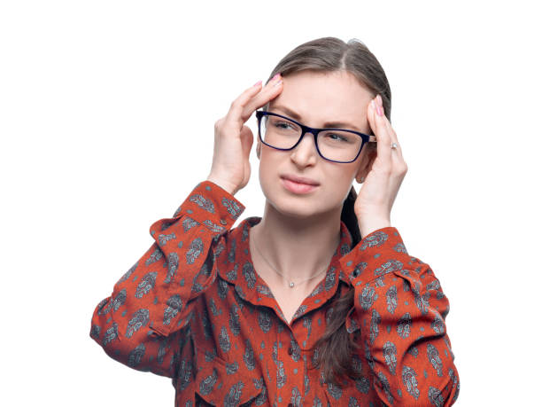 istock Young brunette woman with eyeglasses wearing red patterned blouse feeling headache. Negative suffering emotion on her face. Studio portrait isolated on white with high resolution 1146707021