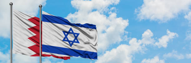 Bahrain and Israel flag waving in the wind against white cloudy blue sky together. Diplomacy concept, international relations. Bahrain and Israel flag waving in the wind against white cloudy blue sky together. Diplomacy concept, international relations. consul photos stock pictures, royalty-free photos & images