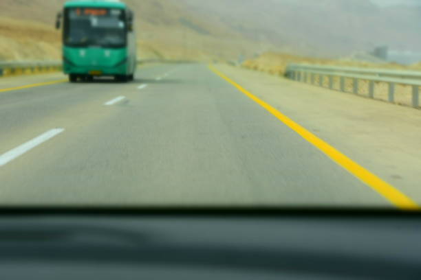 Driving on an asphalt road in front of vehicles