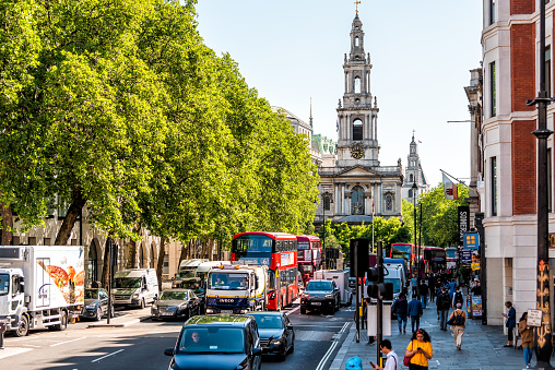 London, UK - June 22, 2018: High angle view of road in center of downtown district city with old architecture St. Mary Le Strand church in summer