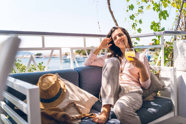 istock Drinking orange juice at seaside cafe 1146712428