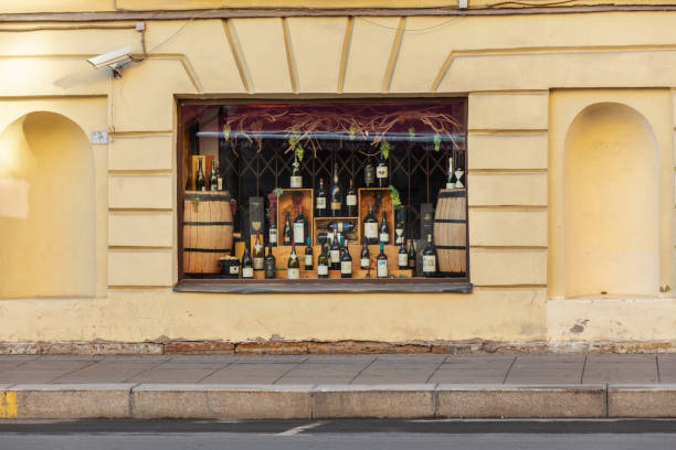 St. Petersburg, Russia - May 01, 2019: An assortment of wine bottles in a restaurant window.  ancient wall and window of the restaurant