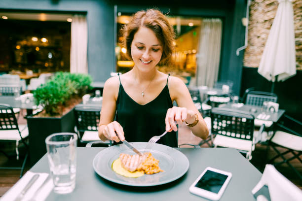 istock Woman enjoying dinner in gourmet restaurant 1146715605