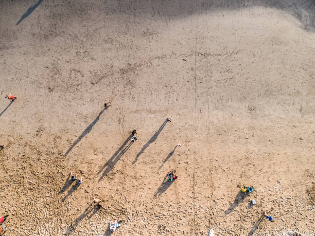 istock People on the beach with drone 1146718770