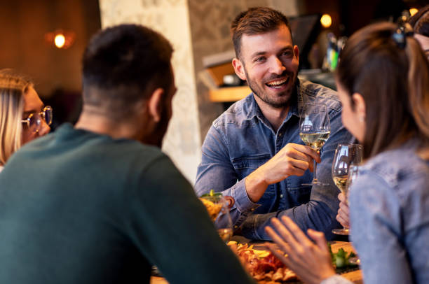 istock Group of young friends having fun in restaurant. 1146719641