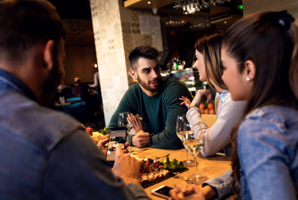 istock Group of young friends having fun in restaurant. 1146720251