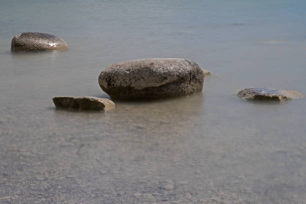 istock rocks lying in shallow water 1146723537