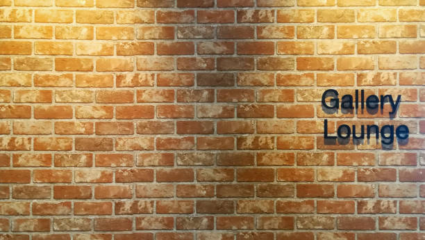 istock orange brick wall with lighting and gallery lounge text sign 1146724710