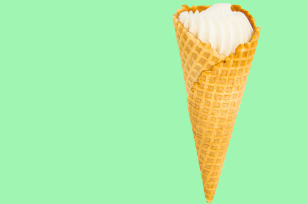 istock Ice cream cone vanilla on pastel green background. Copy space 1146725334