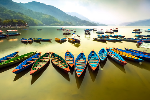 Amazing view on Phewa Lake. colorful boats queued at a midday.Province of Pokhara Nepal