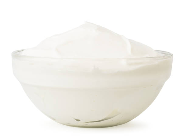 istock Sour cream in a glass plate close - up on a white. Isolated. 1146730792