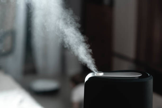 the steam from the humidifier in the night - ionization imagens e fotografias de stock