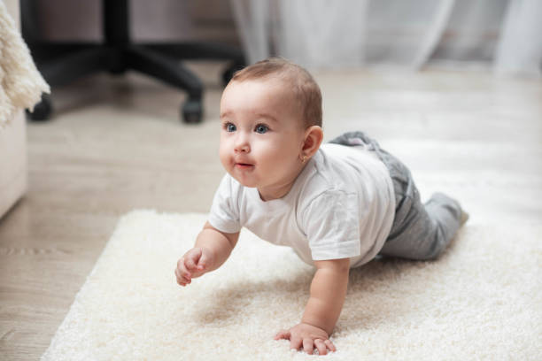 istock Smiling crawling baby boy at home on floor 1146730879