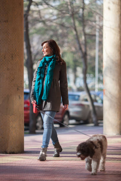 istock woman taking her dog for a walk 1146732033