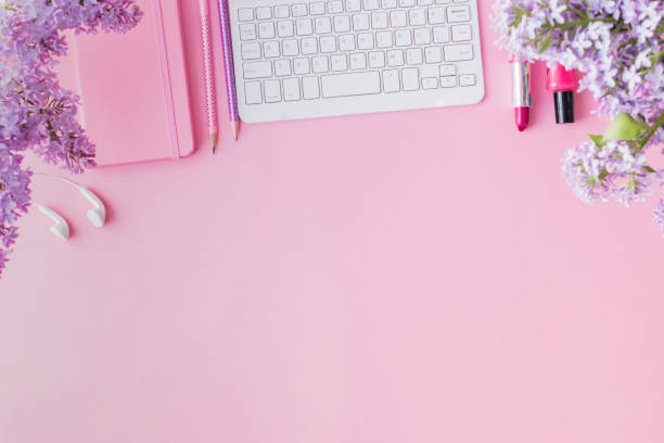 istock Flat lay blogger or freelancer workspace with a notebook and branches of lilac on a pink background 1146732282