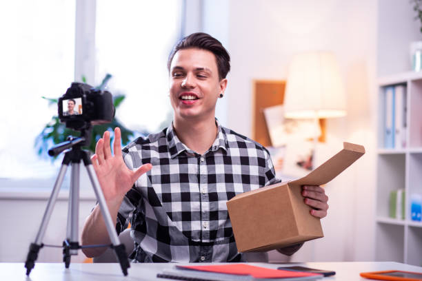 istock Smiling guy enjoying creation of video content 1146734476